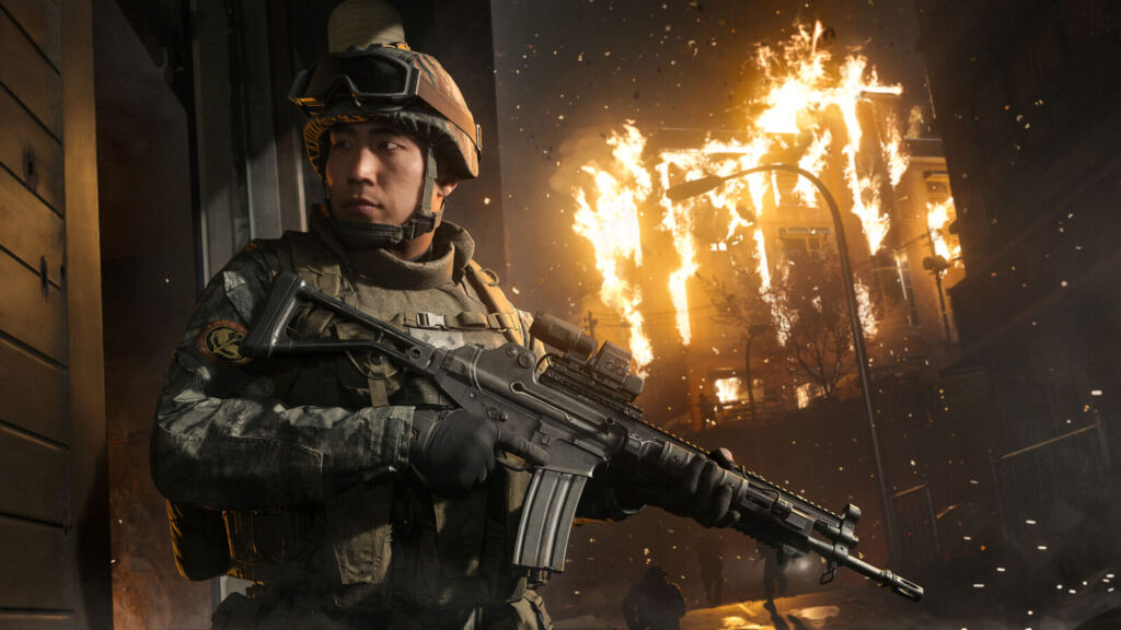 Operador armado diante de um prédio em chamas em Call of Duty: Modern Warfare 4